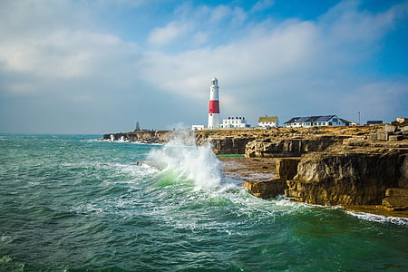 white and red lighthouse near the cliff thumbnail