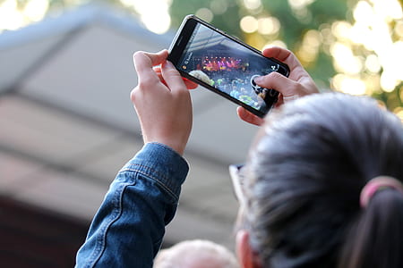 woman holding powered-on iPhone thumbnail