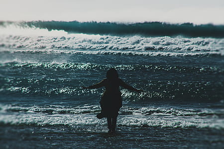 woman standing in front of waving sea thumbnail