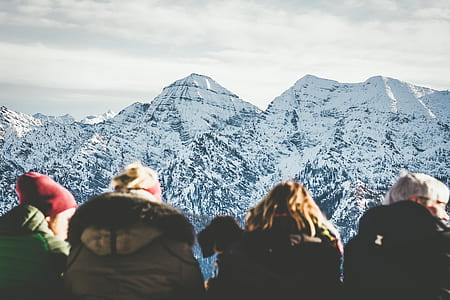 person overlooking snow coated mountain during daytime thumbnail