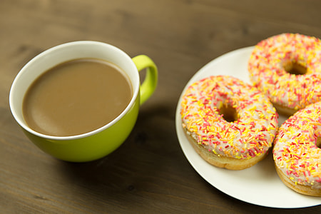 Coffee cup and donuts on desk thumbnail