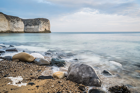 body of water and stones on the shore thumbnail