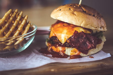 Closeup Photography of Bun With Cheese, Patty, Egg, and Bacon thumbnail