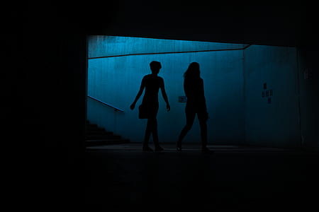 silhouette of two people walking near wall thumbnail