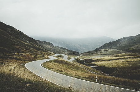 highway surrounded with field during daytime thumbnail