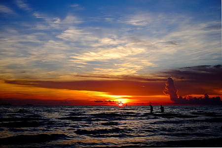 people playing on beach during sunset thumbnail
