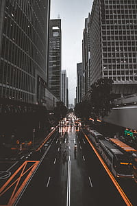 time lapse photography of bus on road near white buildings thumbnail