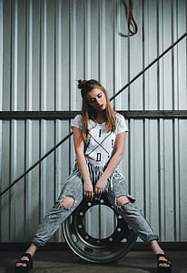 photo of woman sitting on vehicle wheel thumbnail