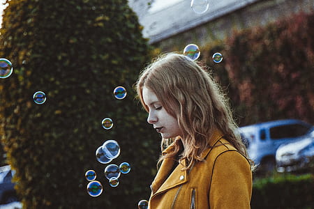 woman in shallow focus standing beside trees thumbnail