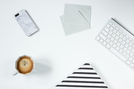 Apple wireless keyboard beside white paper thumbnail