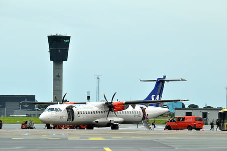 airplane beside red van thumbnail