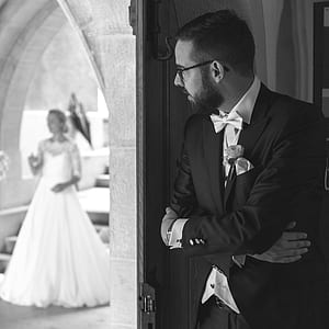 grayscale photography of bride looking for her groom thumbnail