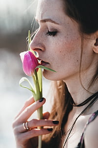 woman smelling pink tulip bud thumbnail