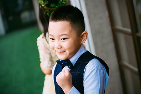 smiling boy standing near door thumbnail