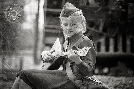 woman wearing hat and dress playing balalaika instrument thumbnail