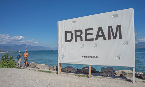 Dream signboard near body of water thumbnail
