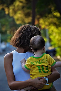 woman carrying baby thumbnail
