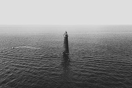 lighthouse surrounded by water thumbnail