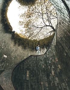 man standing on concrete road during daytime thumbnail