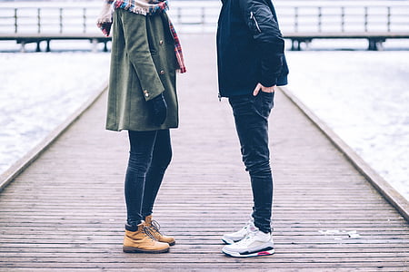 person standing in front of the woman wearing green coat thumbnail