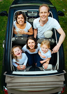 photo of family in convertible car during daytime thumbnail