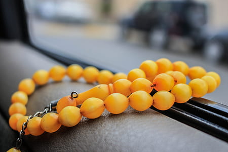 shallow focus photography of yellow tesbih prayer beads thumbnail