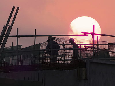 person wearing hard hat behind sunset thumbnail