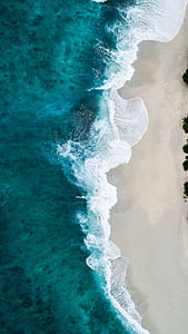 aerial photo of seashore waves during daytime thumbnail