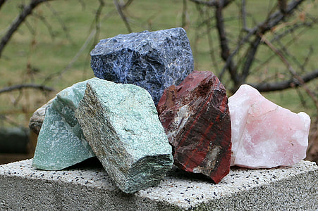 four assorted-color gemstones on concrete deck thumbnail