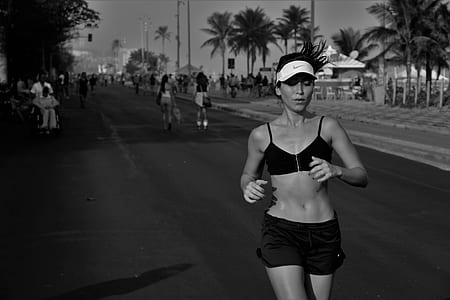 woman jogging on asphalt road thumbnail