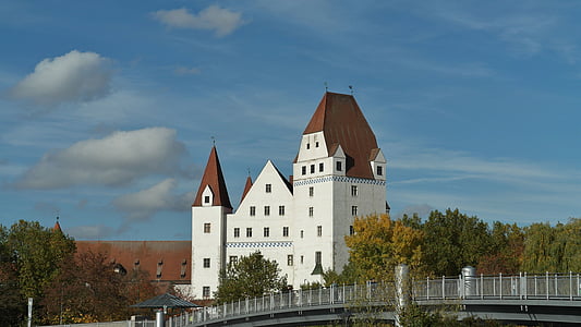 white concrete building near bridge under clear blue sky thumbnail