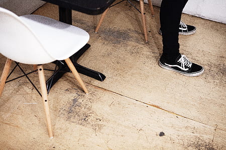 person wearing black-and-white Vans Old Skool shoes thumbnail