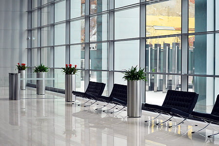 clear glass-panel building with black metal bench thumbnail