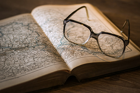 Map in open book and reading glasses thumbnail