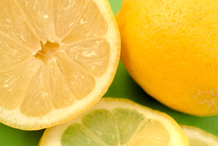 sliced lemons on green surface thumbnail