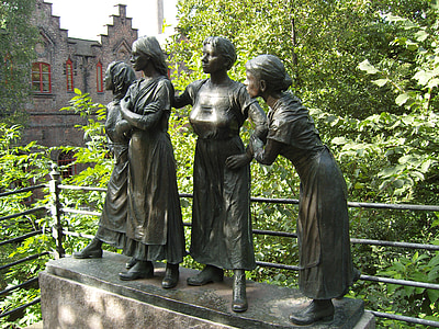 four standing women statue near tree thumbnail