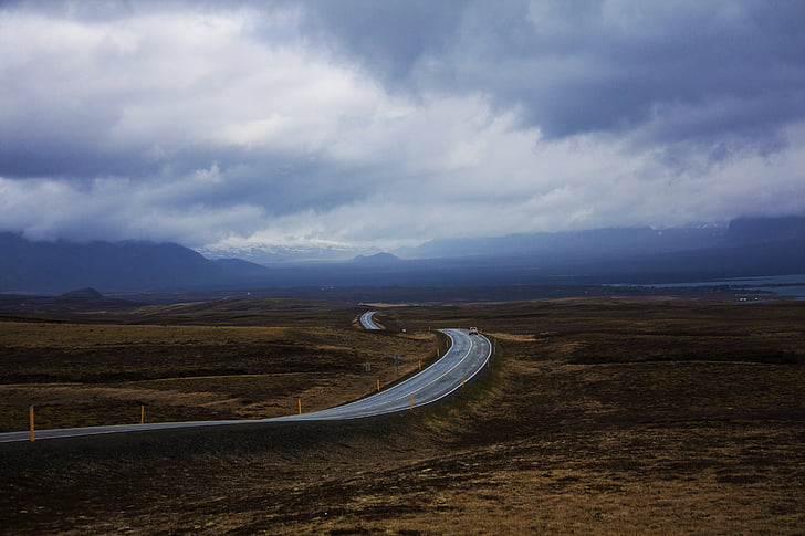 asphalt road under clouds