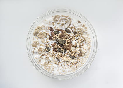 flake and cereal oat with milk on clear glass bowl thumbnail