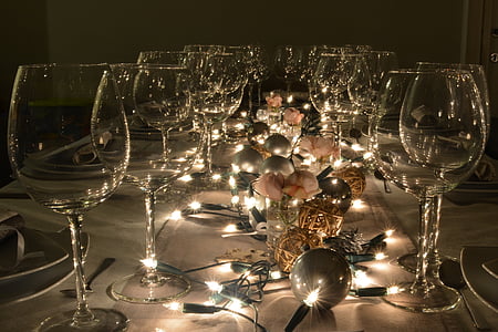 string lights and wine glasses on table thumbnail