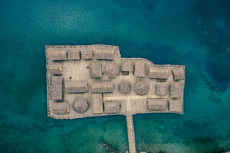 gray wooden houses on a body of water thumbnail