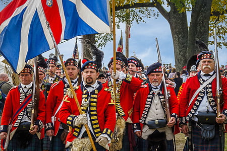 soldier marching while holding guns and flag thumbnail