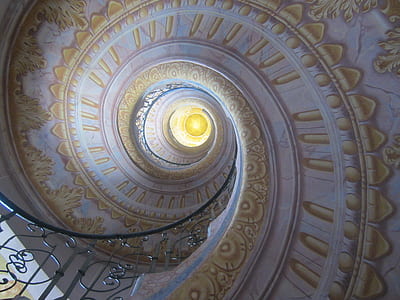 low angle of white and yellow floral spiral staircase ceiling thumbnail