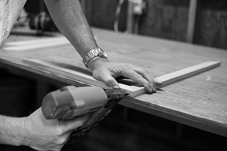 grayscale photography of person wearing wristwatch thumbnail