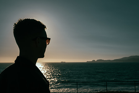 man in the sea shore during the golden hour thumbnail