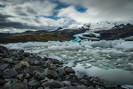 river with glaciers under cloudy sky during blue hour thumbnail