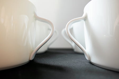 close up photo of four white ceramic mugs thumbnail