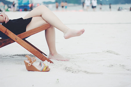 person sitting on wooden deck chair thumbnail
