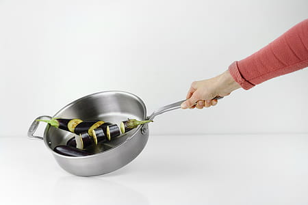 Person Holding Stainless Steel Casserole thumbnail