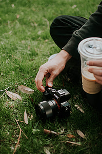person holding black Sony bridge camera thumbnail