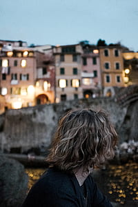 selective focus photography of woman looking at concrete wall thumbnail